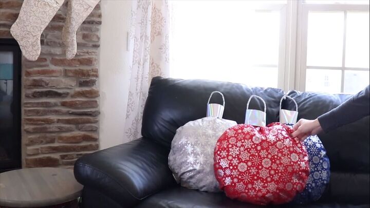 Placing the DIY ornament pillows on the sofa