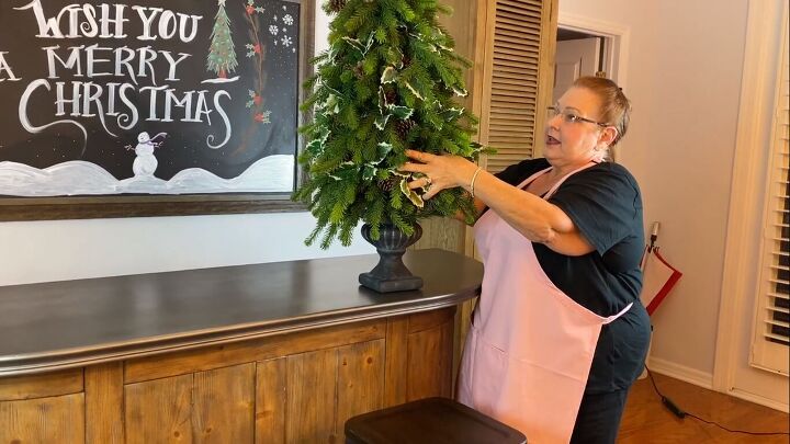 Placing the topiary on top of an urn