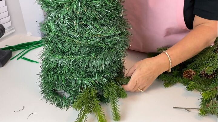 Adding evergreen picks to the topiary