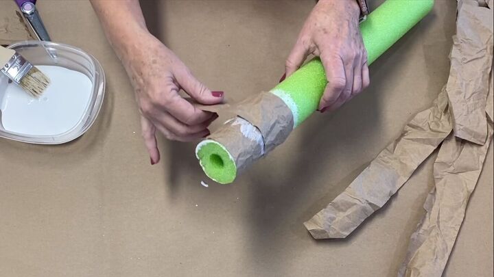 Gluing paper strips to the pool noodle