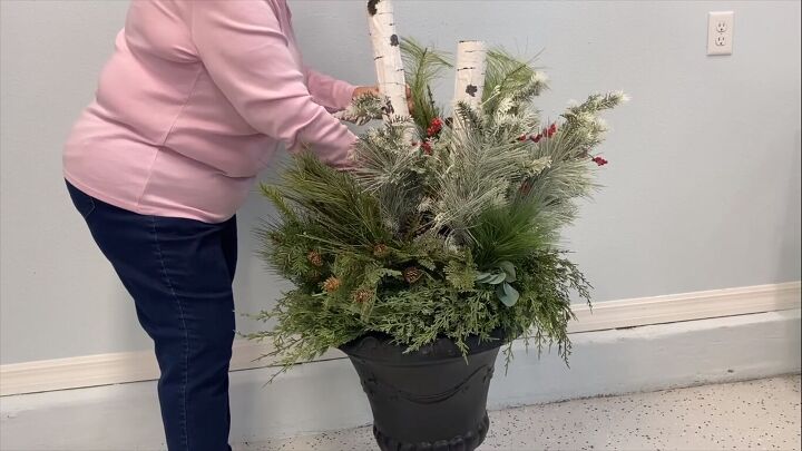 Sticking the DIY birch logs in the planter