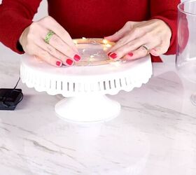 Placing the embroidery hoop on a cake stand