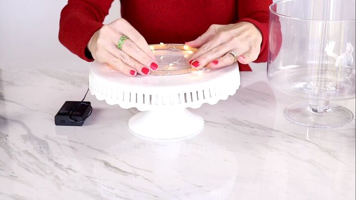 Placing the embroidery hoop on a cake stand