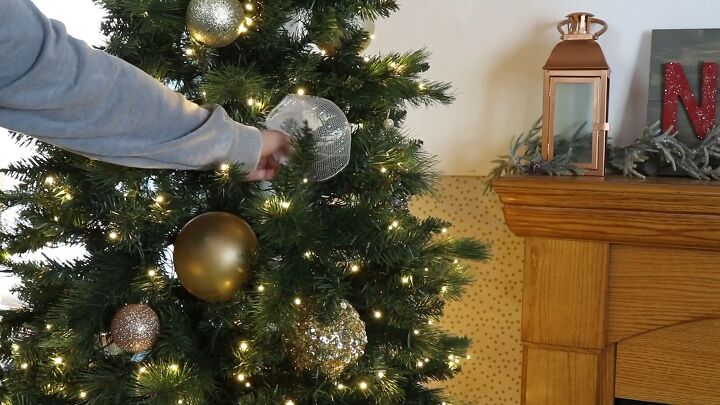 Mesh ribbon ornaments tucked into gaps on a Christmas tree