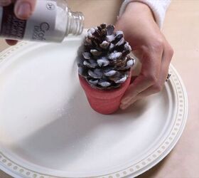 Pouring glitter on the pine cone