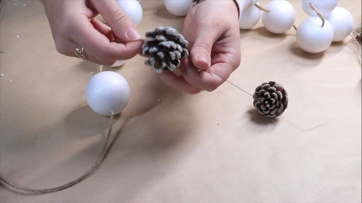 Wrapping craft wire around pine cone