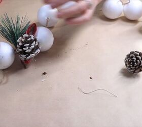 Attaching the pine cone to the twine
