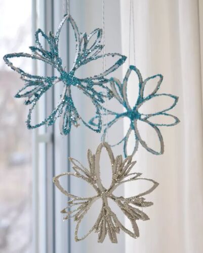 Glittery snowflake crafts made out of toilet roll tubes