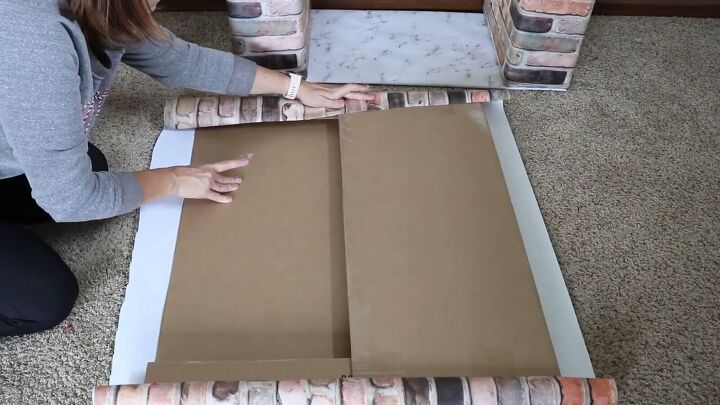 Wrap a square piece of cardboard with brick paper
