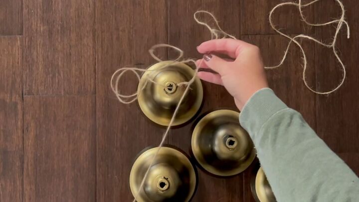 Create a layered effect by tying twine to the Christmas bells