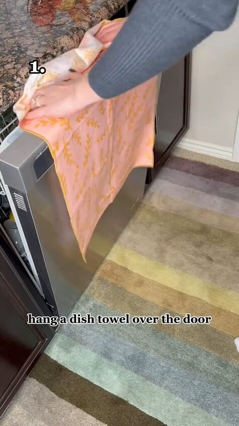 dishwasher cleaning hacks, Hanging a dish towel over the dishwasher drawer