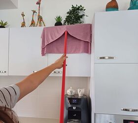 Cleaning kitchen cabinets with a squeegee and cloth