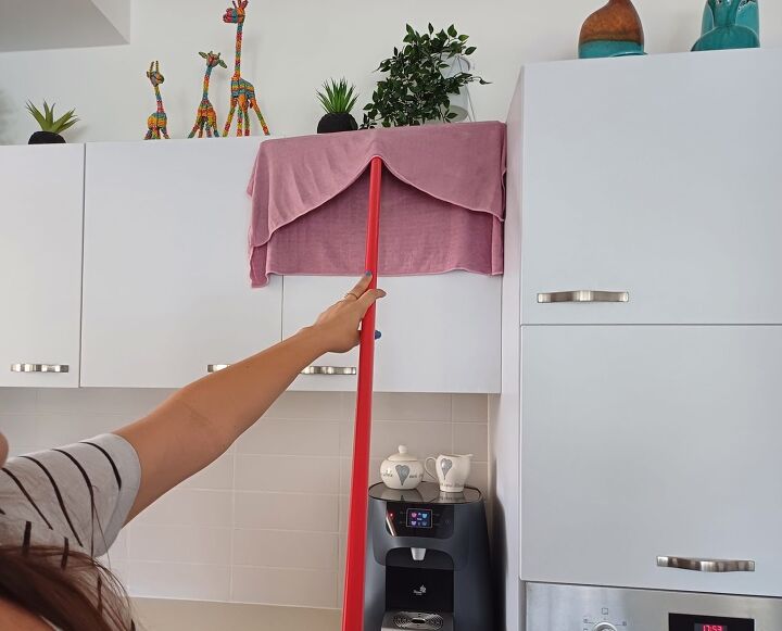 Cleaning kitchen cabinets with a squeegee and cloth