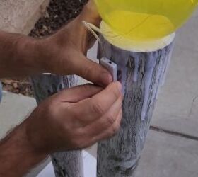 diy christmas lamp post, Secure the switch to the back of the giant candles with hot glue