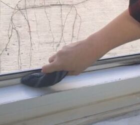 pour vinegar into your windowsill for an easy cleaning hack, Pushing a knife wrapped in a towel along the edges