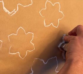 Stamping snowflake shapes on the wrapping paper