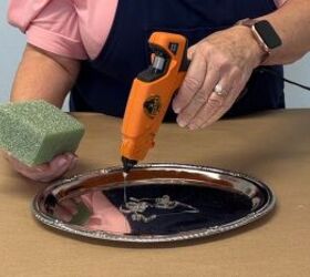 Applying hot glue to a tray