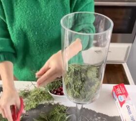 Adding the greenery to a vase