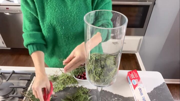 Adding the greenery to a vase