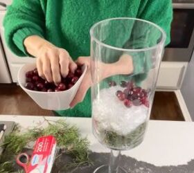 Adding a layer of cranberries to the centerpiece