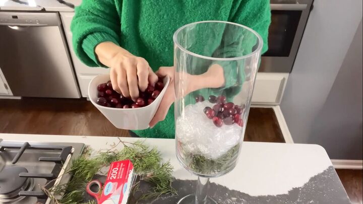 Adding a layer of cranberries to the centerpiece