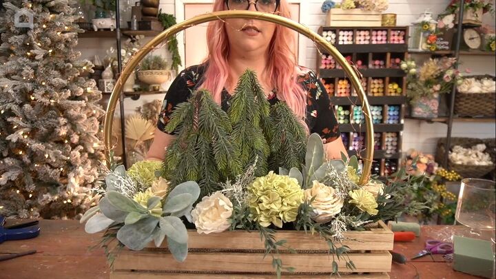 Filling in the centerpiece with green and white flowers