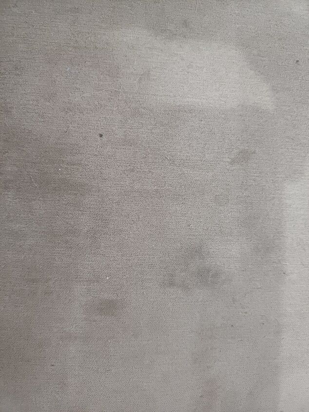 Old and new stains on the arm of a sofa
