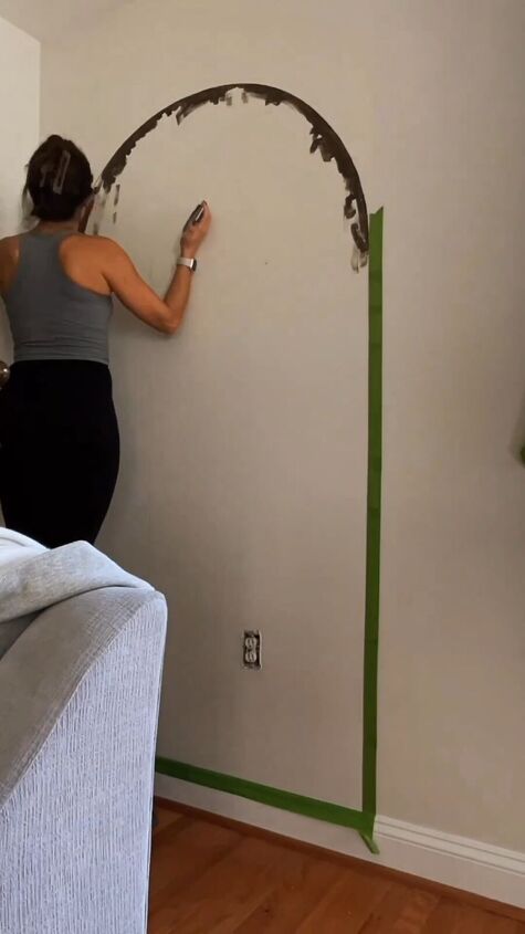 Applying painter's tape to the wall
