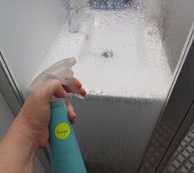 clean shower door, Spray vinegar onto the glass of the door