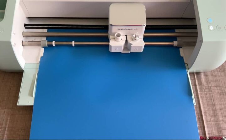 Close up of a Cricut machine cutting a piece of removable vinyl