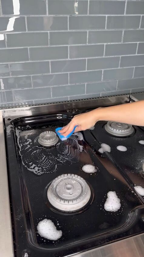 Wiping down the stove surface
