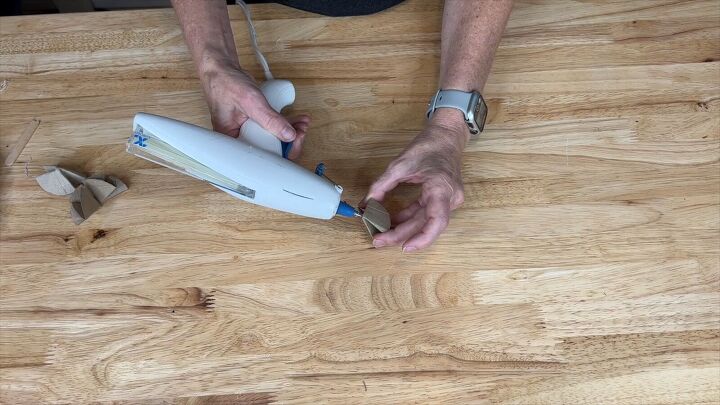 Place a drop of glue to the top of a triangle