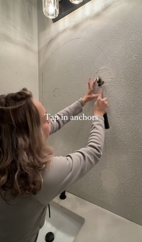 how to hang mirror on wall, Tapping in the anchors