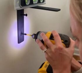 The clever reason this woman hangs a strong bracket RIGHT behind her couch