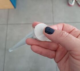 Clear double sided tape being placed at the end of a tension rod