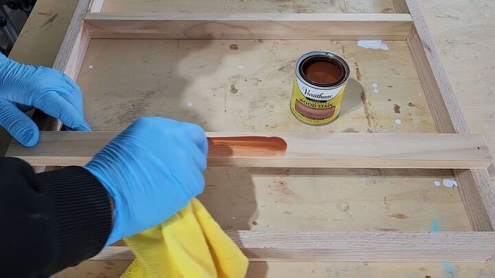 Stain the wood in a color that matches your cabinets