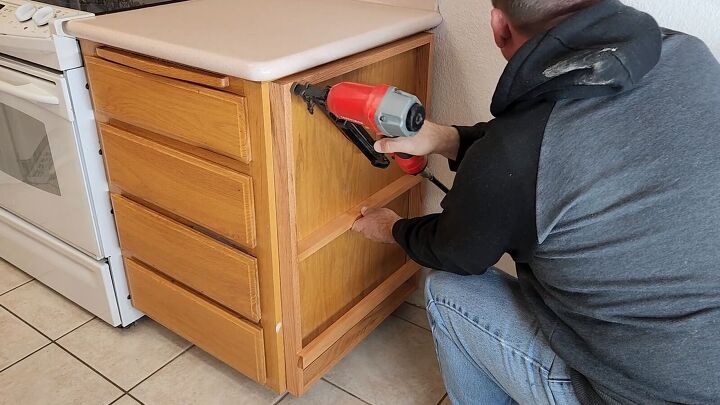 Attach the utensil holder to the side of the cabinet