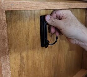Stick a large Command hook to the cabinet