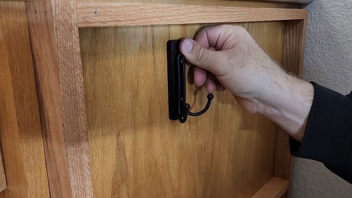 Stick a large Command hook to the cabinet