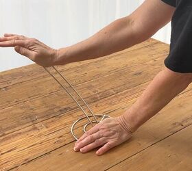 She bends 4 paper towel holders and puts them on her bed—brilliant!