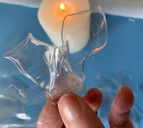 She cuts up a soda bottle and holds it over a flame for this amazing idea