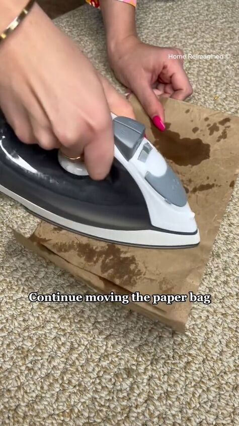 how to get wax out of carpet, Moving the iron over the paper bag