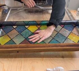 Applying a window cling to create the faux stained glass effect