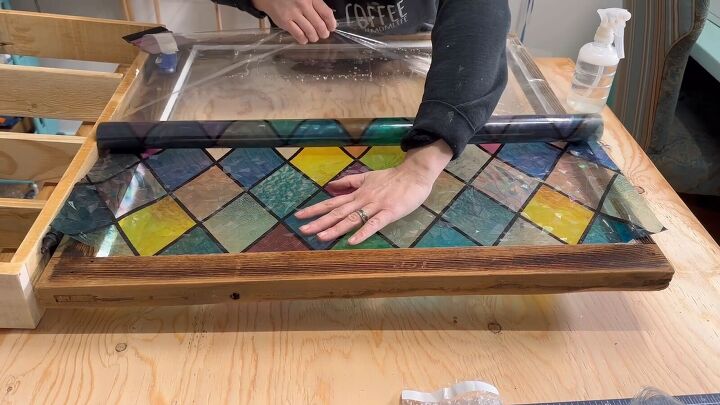 Applying a window cling to create the faux stained glass effect