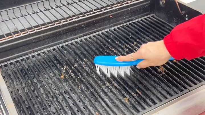 Grill grates being scrubbed clean