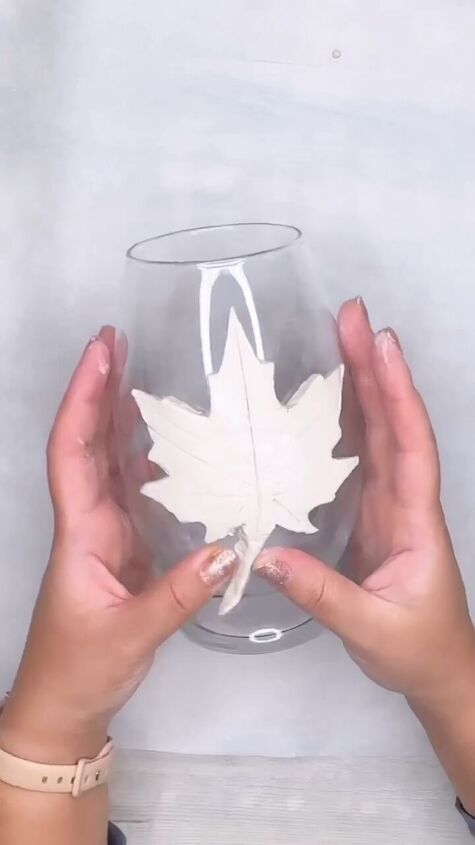 Attaching the clay leaf to the vase