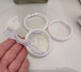 Tying fabric strips onto the shower curtain ring