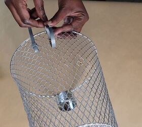 Attaching silver zip ties to the bottom of the wire basket