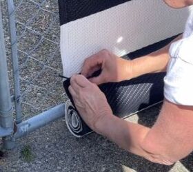 Securing the bottom of the rug to the fence with cable ties