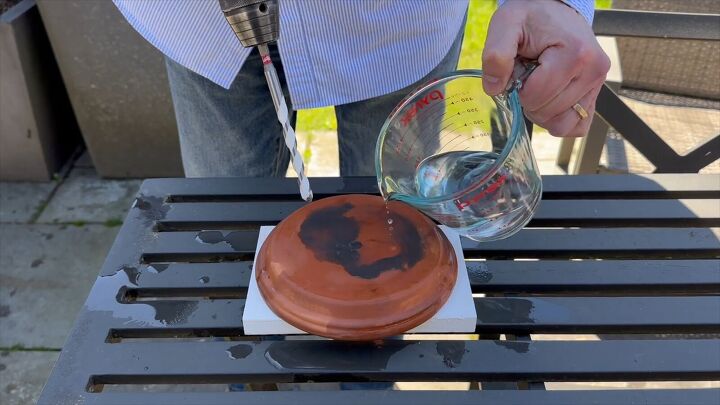 Creating holes for water flow in the terracotta pots and saucers